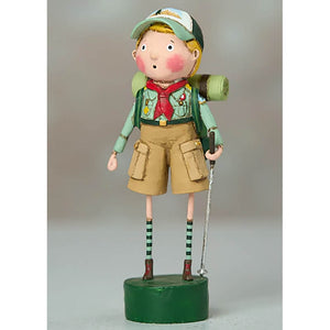 Whimsical Boy Scout figurine with striped socks and hiking gear standing on a green base.