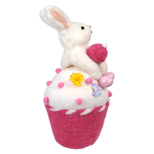 Decorative pink and white cupcake plush with a bunny rabbit on top.