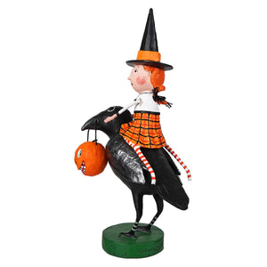 A lori mitchell halloween whimsical figurine called raven’s flight featuring a witch with orange hair riding a black crow