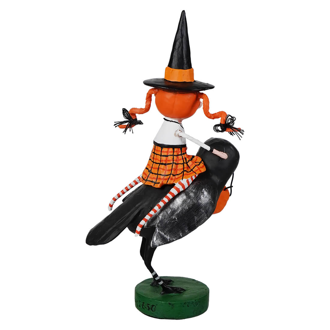 Orange pumpkin-headed witch with black and orange hat riding a glossy black crow on green base lori mitchell halloween raven’s flight