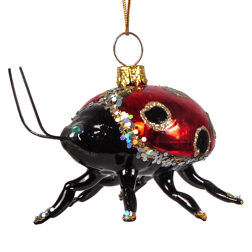 A glossy red and black glass beetle ornament with gold and silver glittery accents and a metallic hanging loop