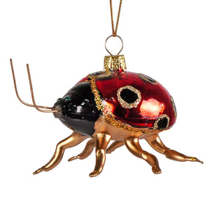 A glossy red and black glass beetle ornament with gold glitter accents metallic legs and antennae by cody foster