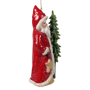 Red coat santa holding tree and star ornament with white fur trim and glittery texture is a festive holly santa ornament