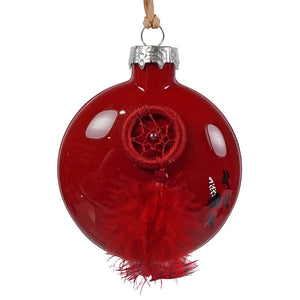 A glossy red glass christmas ornament with a woven red dreamcatcher design featuring a central bead and feathers