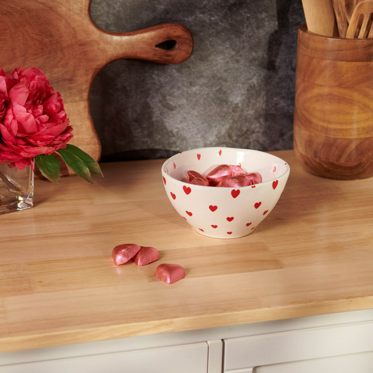 White ceramic bowl decorated with red hearts.