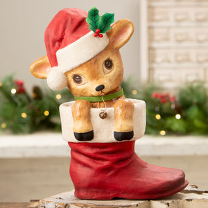 A charming beige reenie reindeer figurine with a red santa hat in a glossy red boot by bethany lowe design