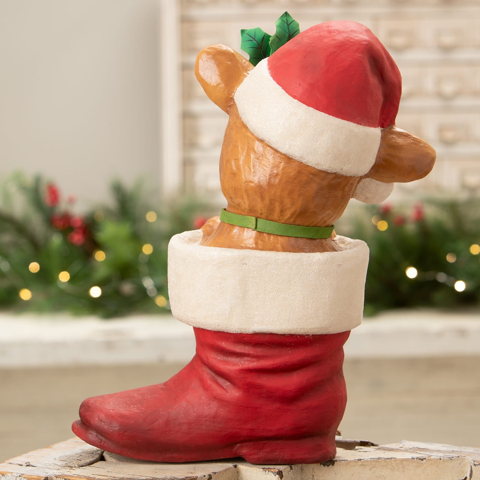 A brown bear figurine in a red christmas stocking wearing a santa hat from bethany lowe design reenie reindeer decor