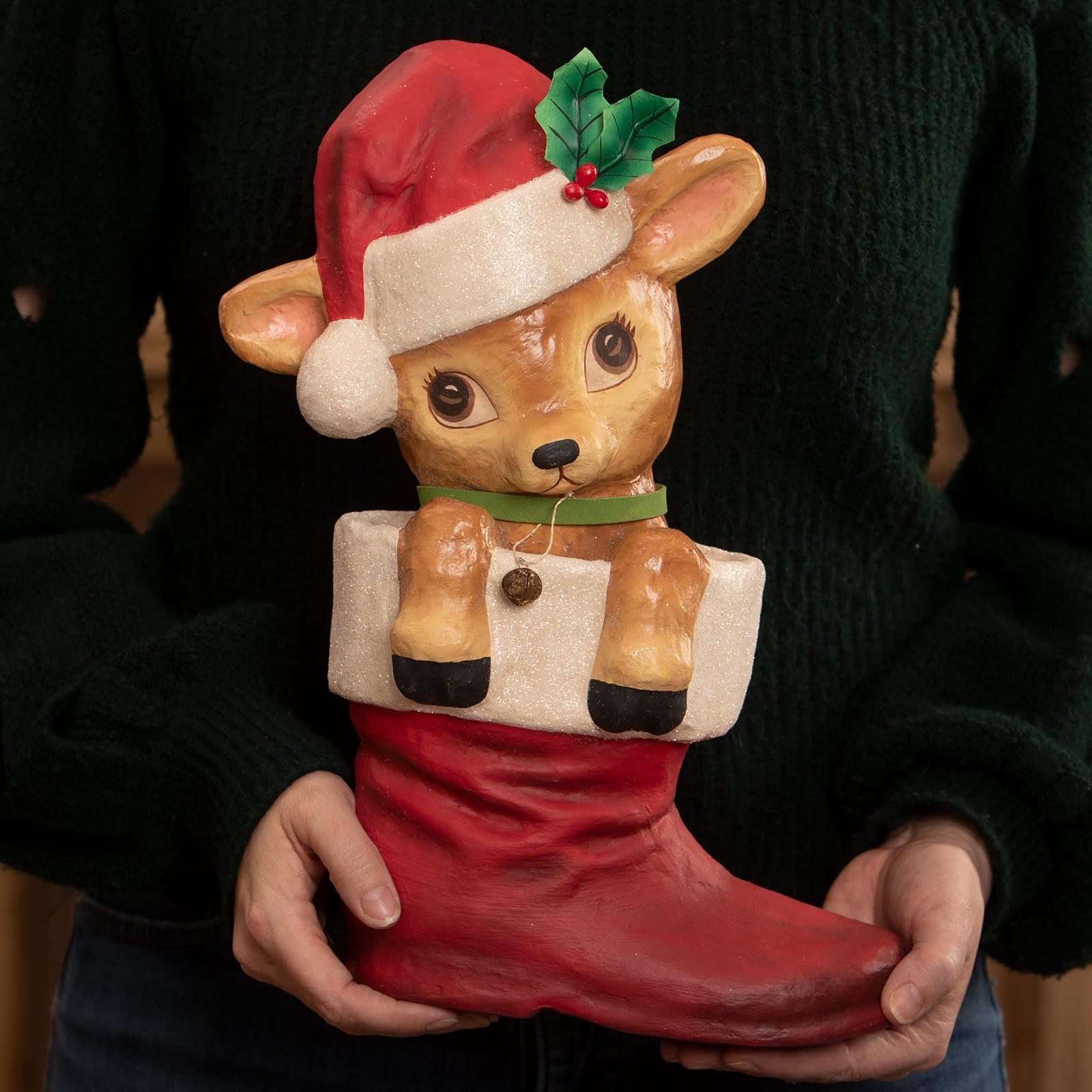 A charming bethany lowe design reenie reindeer ceramic figurine of a brown fawn in a red christmas stocking
