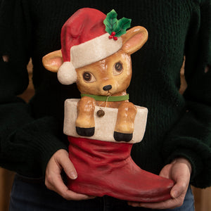 A charming bethany lowe design reenie reindeer ceramic figurine of a brown fawn in a red christmas stocking