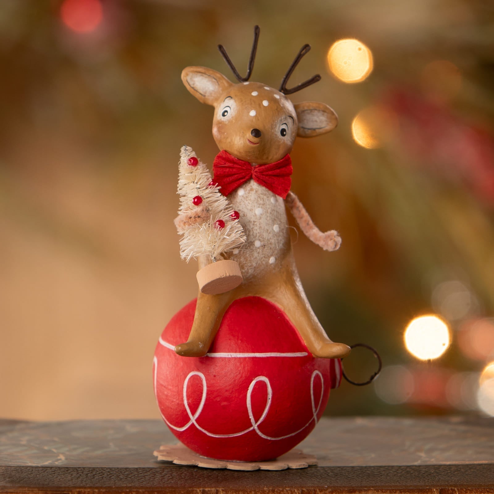 A charming vintage-style reindeer on ornament with tan fur, black antlers, red bow tie by bethany lowe designs