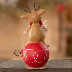 A charming beige reindeer figurine with black antlers and red scarf on a glossy red ornament from bethany lowe designs christmas reindeer figures ornaments & decor
