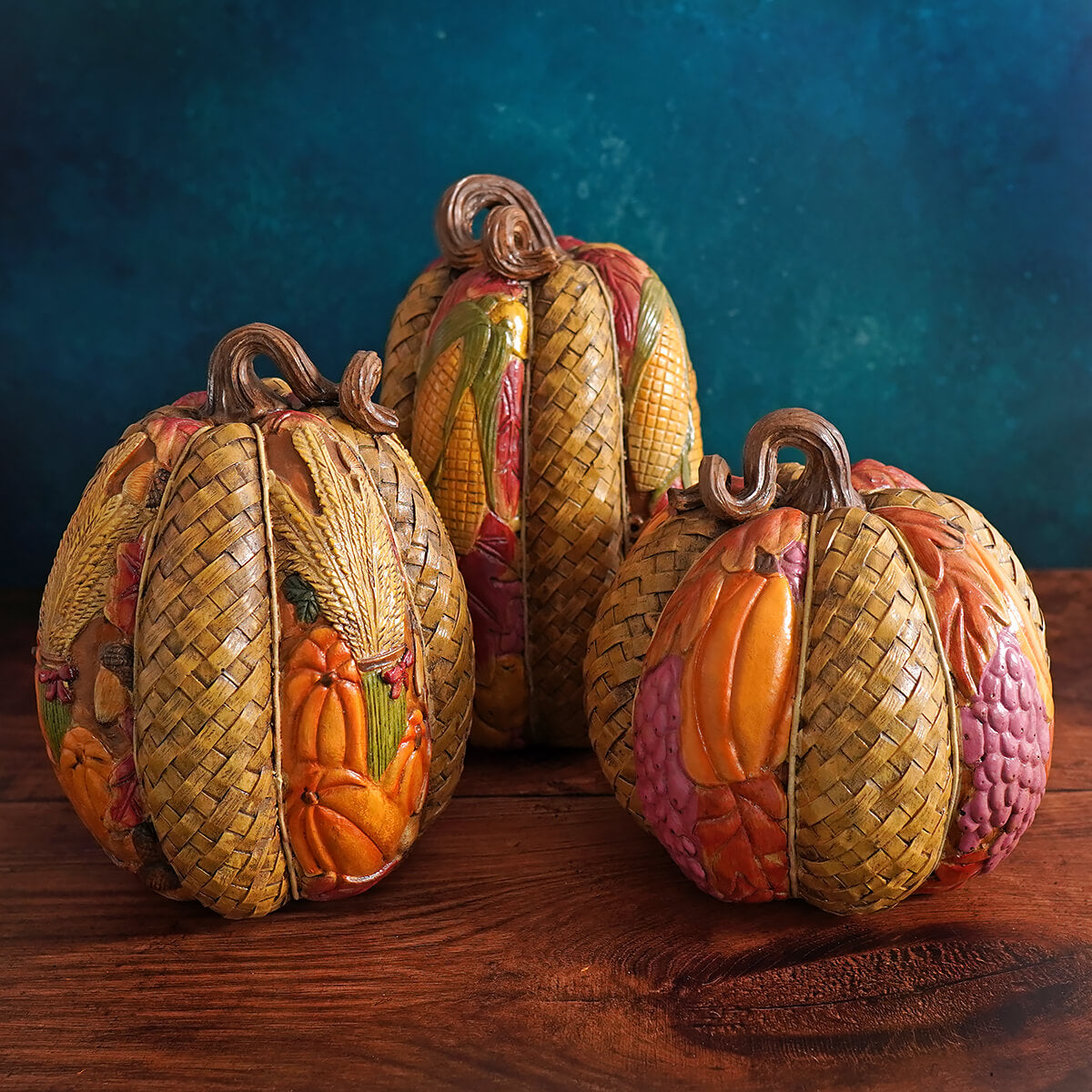 Decorative woven pumpkins with colorful autumn-themed designs and textures.