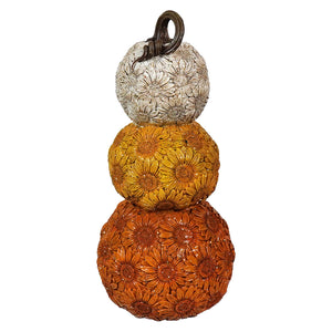 Stack of three decorative pumpkins with floral patterns in autumn colors.