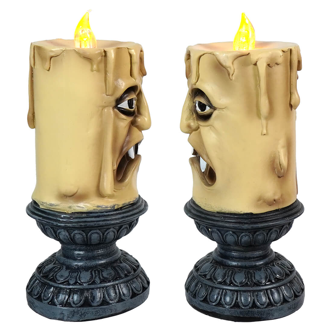 Pair of creepy candle-like decorations with faces and yellow flames on ornate bases.