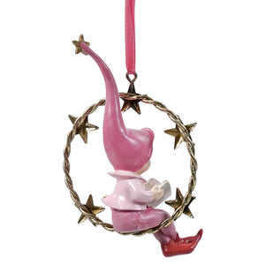 Pink resin swinging pixie holding book with long hat seated in gold finish ornament hoop with star wreath