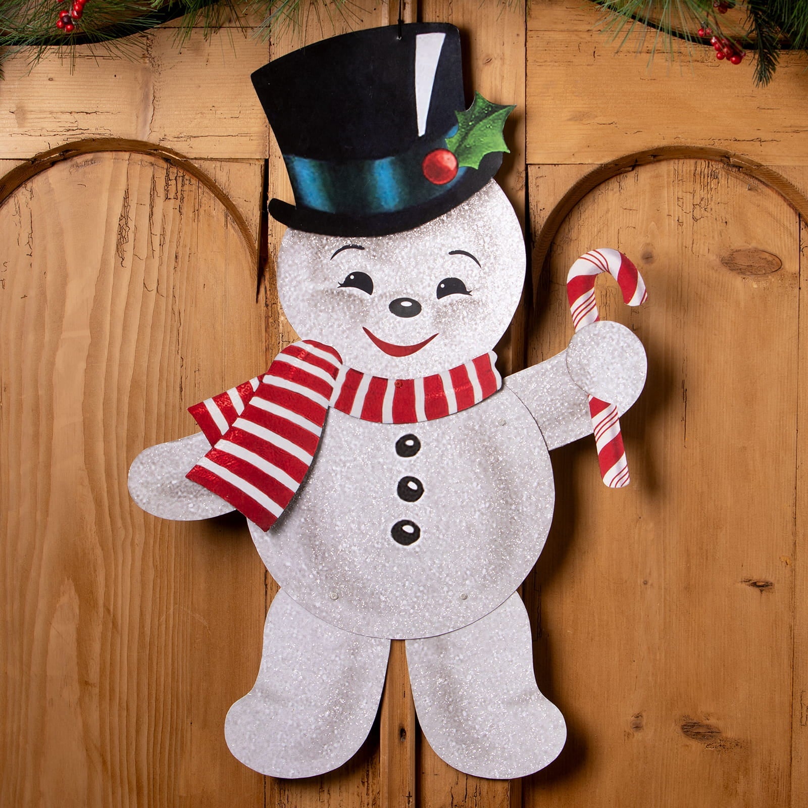 A cheerful silver glitter retro rockin snowman ornament by bethany lowe design holding a red and white candy cane