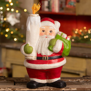 Retro santa figurine by bethany lowe design holding a torch with yellow flame wearing green mittens and carrying gift bag