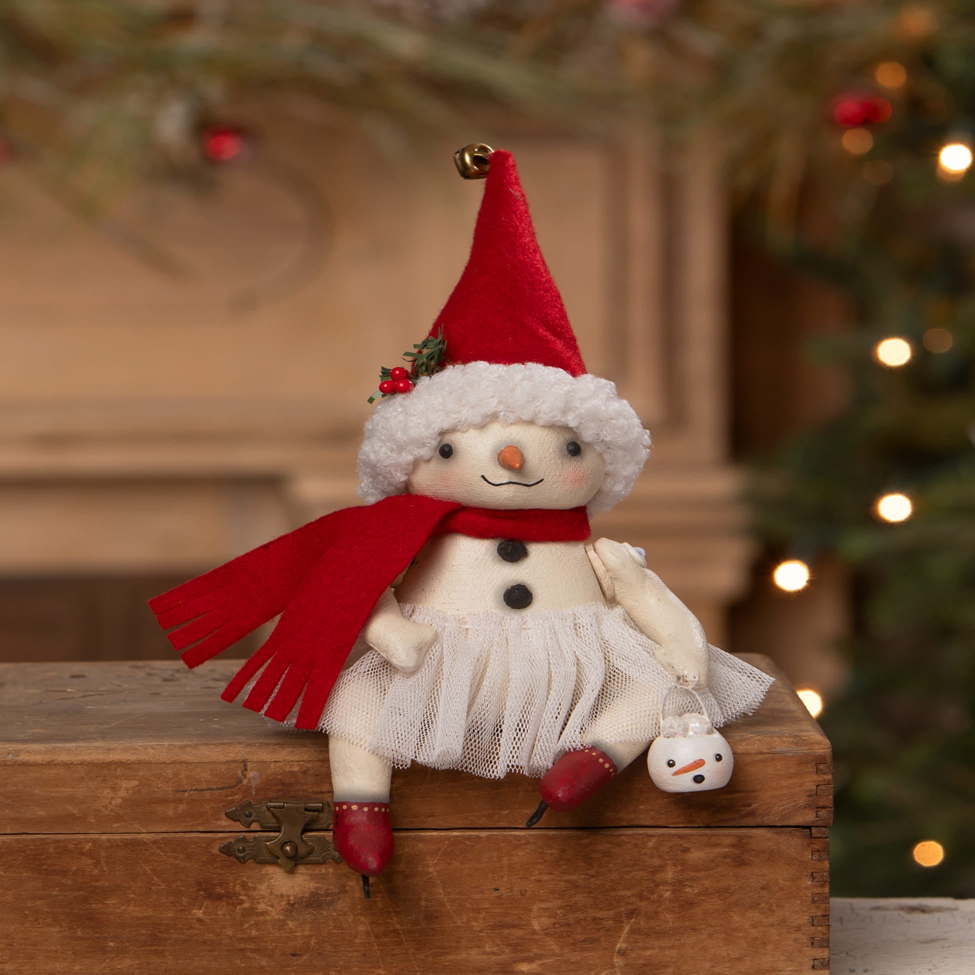 A charming white plush snowman rosemary flake by bethany lowe designs wearing a red velvet santa hat and scarf