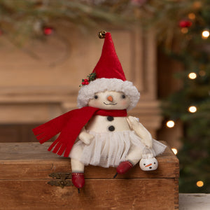 A charming white plush snowman rosemary flake by bethany lowe designs wearing a red velvet santa hat and scarf