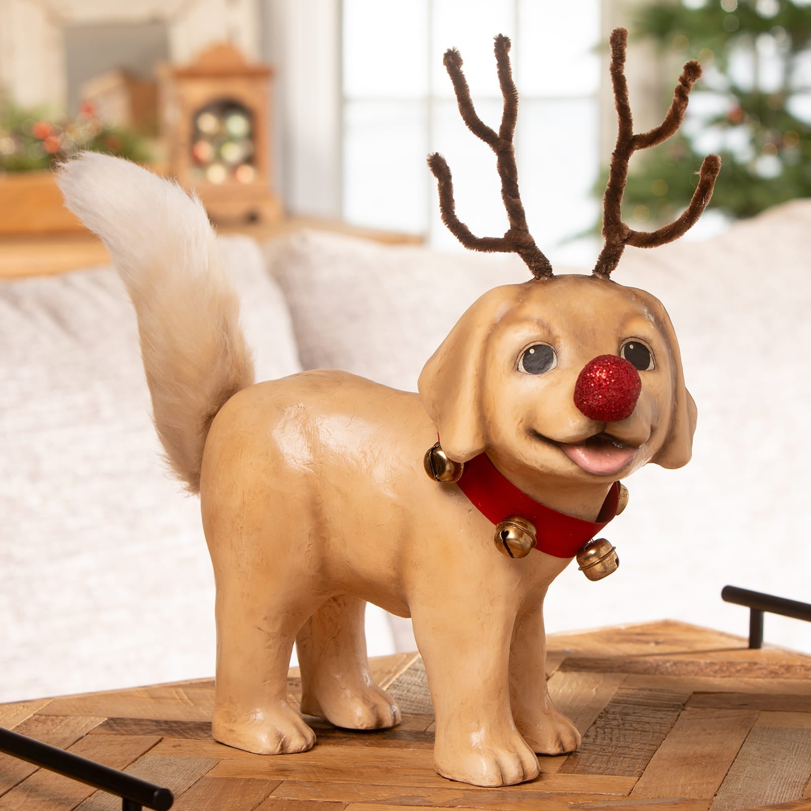 A tan ceramic rudolph puppy figurine with brown pipe cleaner antlers and red collar by bethany lowe design