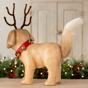 A beige ceramic rudolph puppy figurine by bethany lowe design with brown pipe-cleaner antlers and a red collar with gold bells