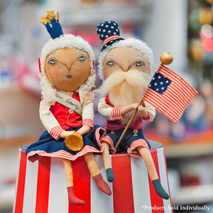 Two handcrafted samuel liberty fabric dolls one as uncle sam waving an american flag and the other wearing a blue crown