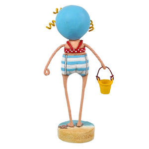 A lori mitchell sandy figurine of a girl with a blue spherical head, yellow curly hair, red polka dot swim top, and striped shorts holding a yellow bucket