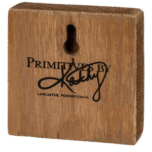 A rustic brown wooden santa block sign with keyhole cutout and black primitives by kathy design engraving