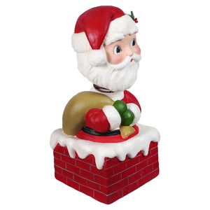 Red and white santa claus bobble head figurine peeking from brick chimney holding green red gift sack by bethany lowe designs