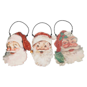 Three vintage-style santa ornaments set with printed faces red glittery hats and black hanging loops perfect for holidays
