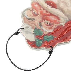 Vintage-style santa ornaments set with a printed face, red glitter scarf, and holly design on wood scrap santa ornaments