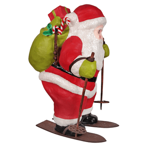 Red and white glittery santa figure on skis with green gloves and sack decorated with candy cane and holly from bethany lowe designs santa delivery collection