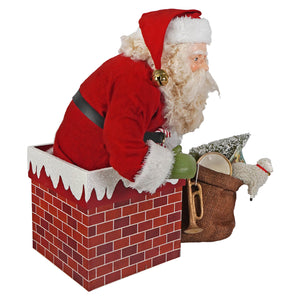 Red santa figure with white fur trim and gold bell seated in brick chimney box from bethany lowe designs folk art santas