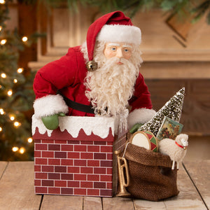 Santa down the chimney figurine by Bethany Lowe Designs features a red velvet suit with white fur trim folk art santas