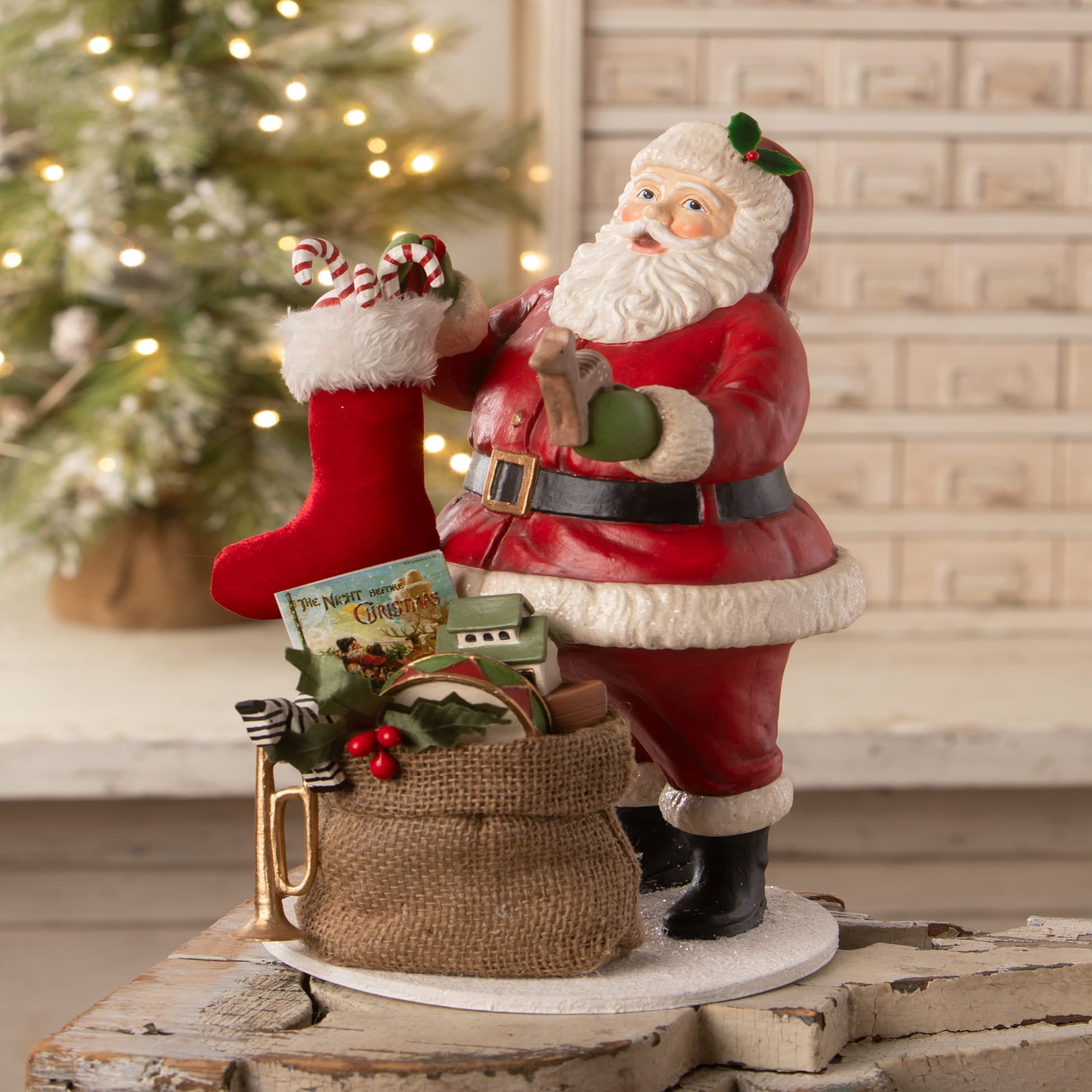 Santa filling the stocking red and white santa figure by bethany lowe designs holding a candy cane decorated stocking