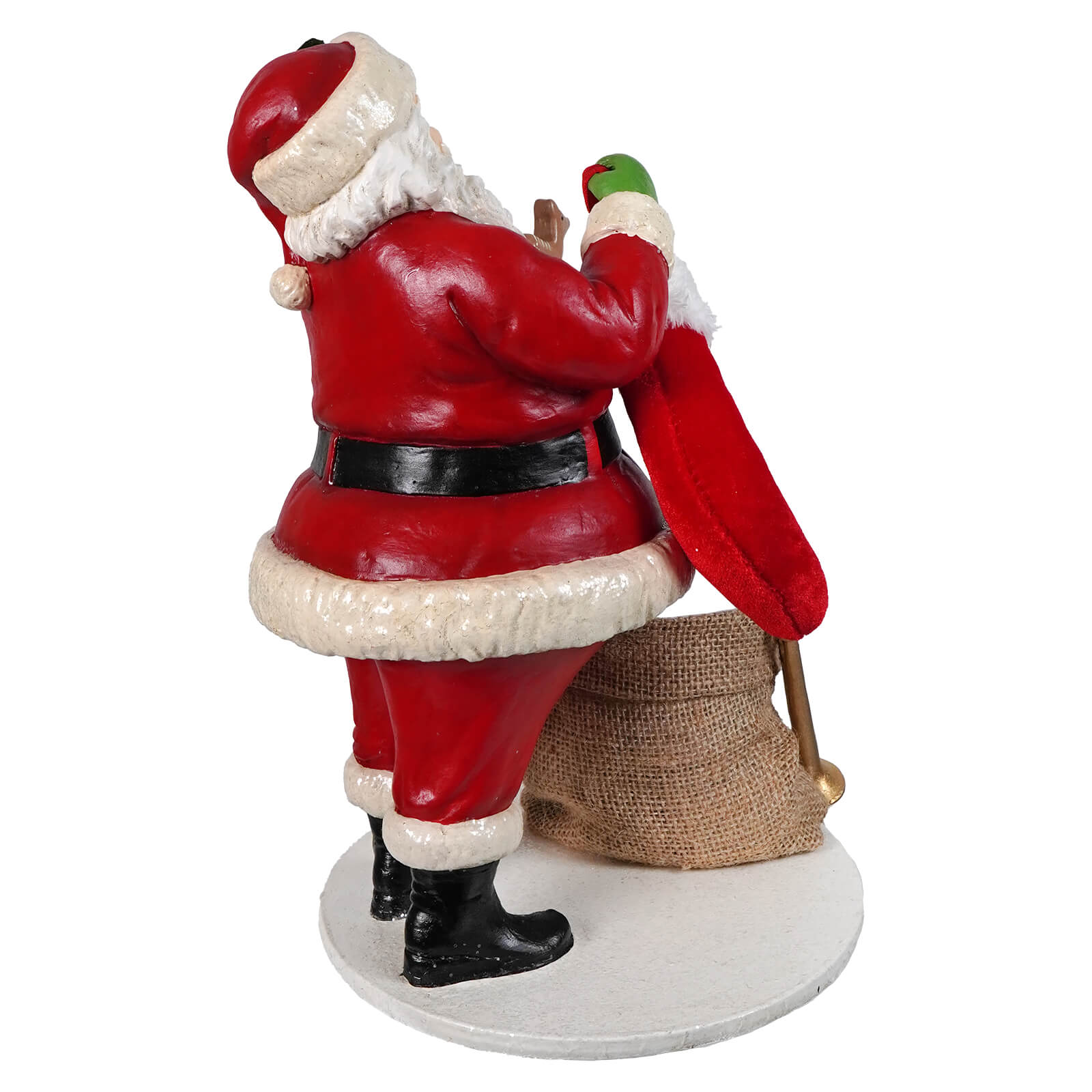 Red and white santa figure by bethany lowe designs holding a green bird and burlap sack santa filling the stocking