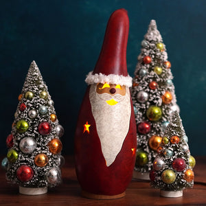 Red lighted santa gourd lantern with white beard and glowing yellow star accents by meadowbrooke gourds