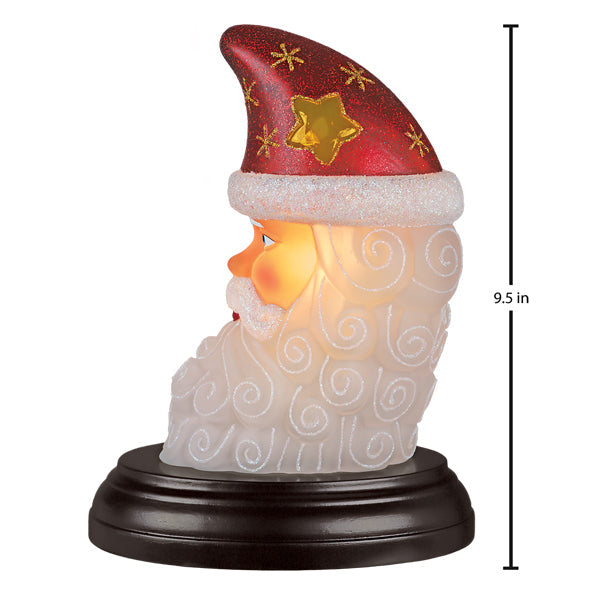 Santa moon face light with red and gold glittery santa hat and white trim glowing as a christmas lighted glass decor piece