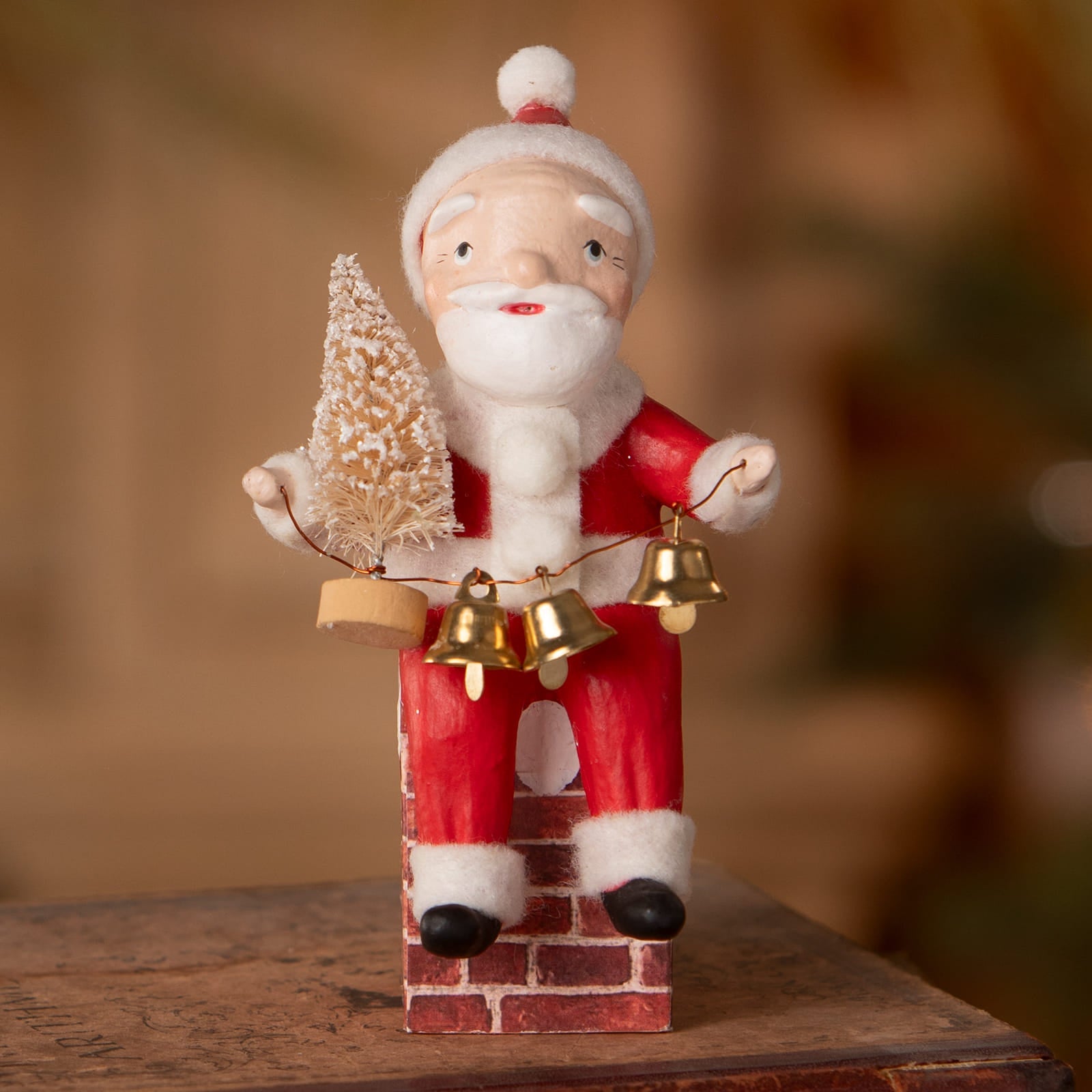 Red and white santa on chimney figurine by bethany lowe designs holding frosted tree and three golden bells