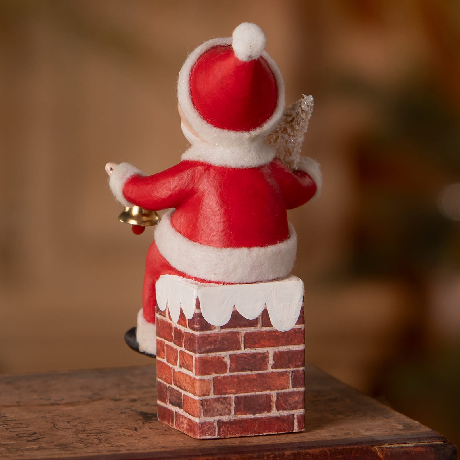 Red and white santa figure with textured fabric seated on brick chimney base from bethany lowe designs folk art santas