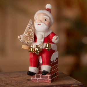 Red and white santa on chimney figurine by bethany lowe designs holding a frosted tree and golden bells folk art santas