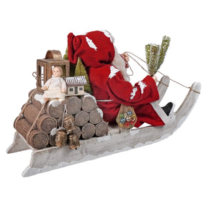 Red and white santa claus figurine seated in rustic weathered wooden log sled from bethany lowe designs folk art santas