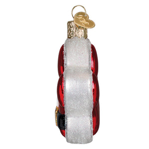Red glass santa paws ornament shaped like a vintage roller skate with white glittery fur trim and gold metal accents figural decor
