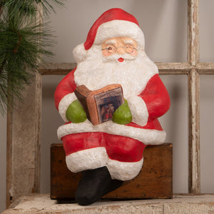 Red and white glittery bethany lowe design santa shelf sitter figurine holding the night before christmas book on wooden block