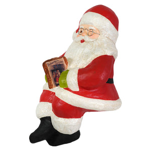 Red and white glittery bethany lowe design santa shelf sitter figurine wearing glasses with the year before christmas book