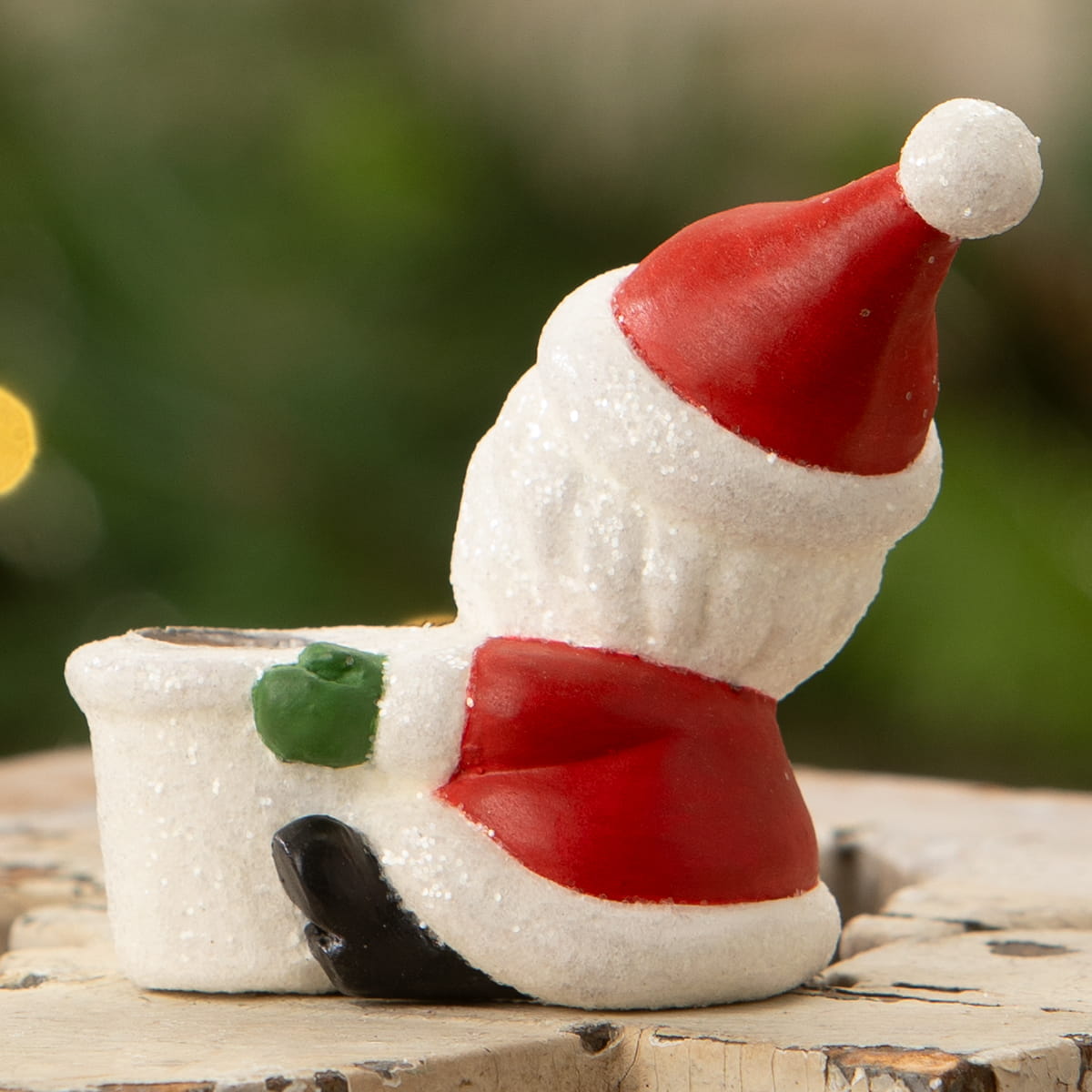A festive santa taper candle holder in glittery resin with red hat and white beard by bethany lowe design for christmas candles & candle holders