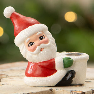 A charming bethany lowe design santa taper candle holder with red hat scarf and green mittens for christmas candles and candle holders