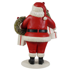 Small santa figure by bethany lowe designs in red and white holding a wreath and christmas presents