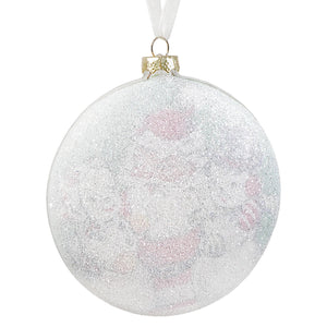 A clear glass disc ornament with silver glitter and pink floral patterns hanging from a white ribbon by bethany lowe