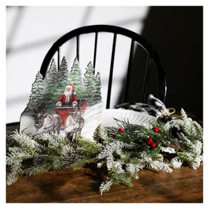 Christmas-themed paper cutout santa claus stand featuring vintage santa claus in red sleigh pulled by reindeer in snowy forest